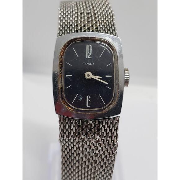 Women's Timex dress watch. Black square face with silver bevel. Decorative band